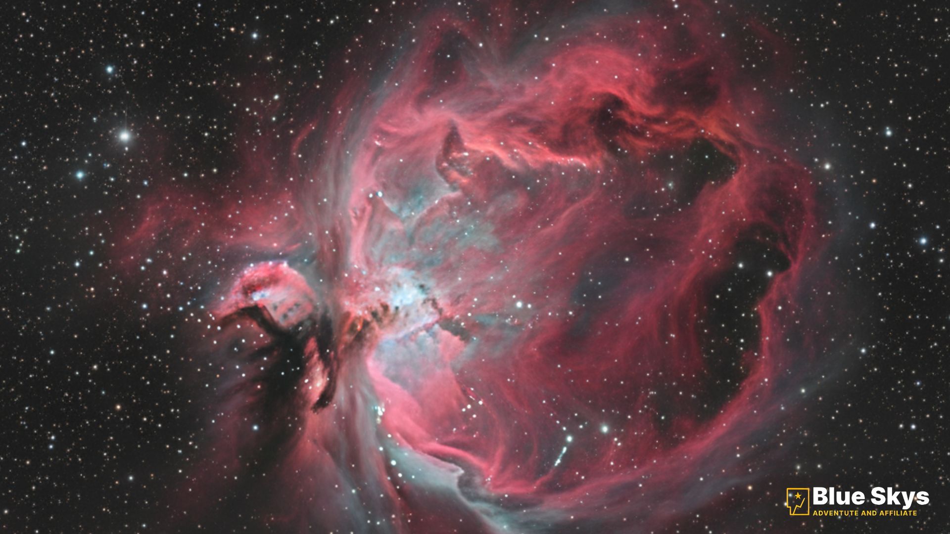 The Pacman Nebula (NGC 281), an emission nebula with red and blue-green hues, featuring dark dust lanes and star-forming regions.