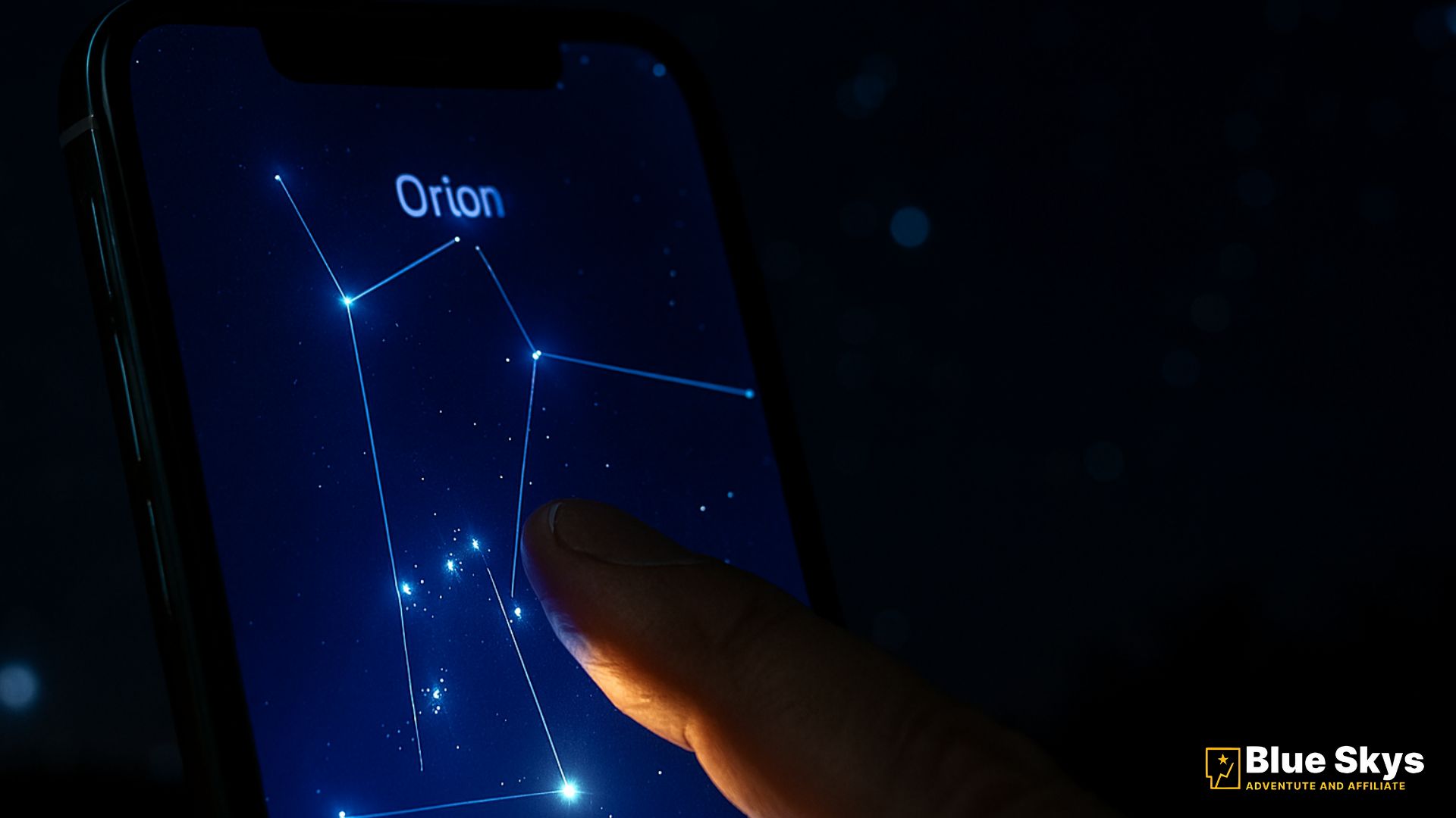 A close-up of a smartphone screen showing the Orion constellation map on a stargazing app, with a finger touching Orion's Belt.